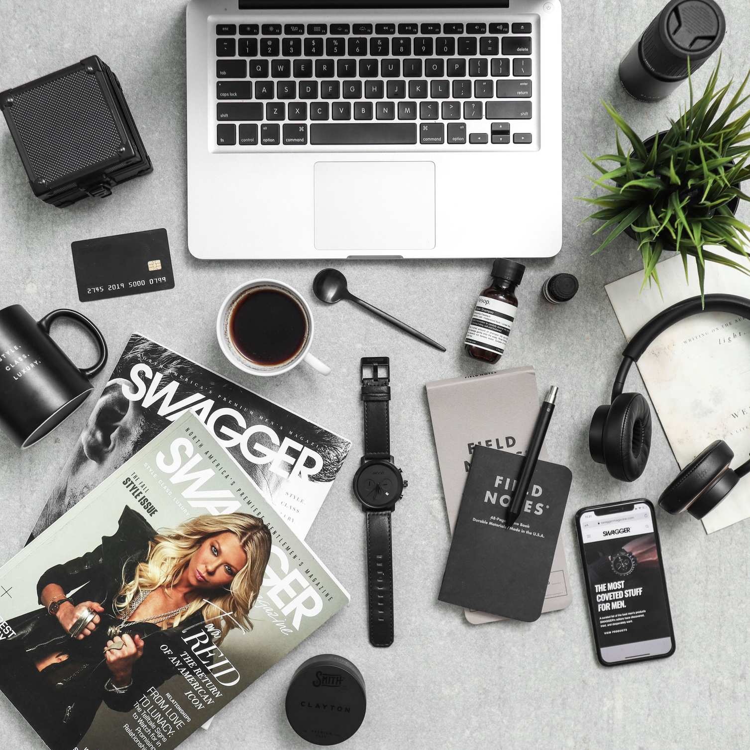 Top-down workspace with phone, laptop, and desk accessories